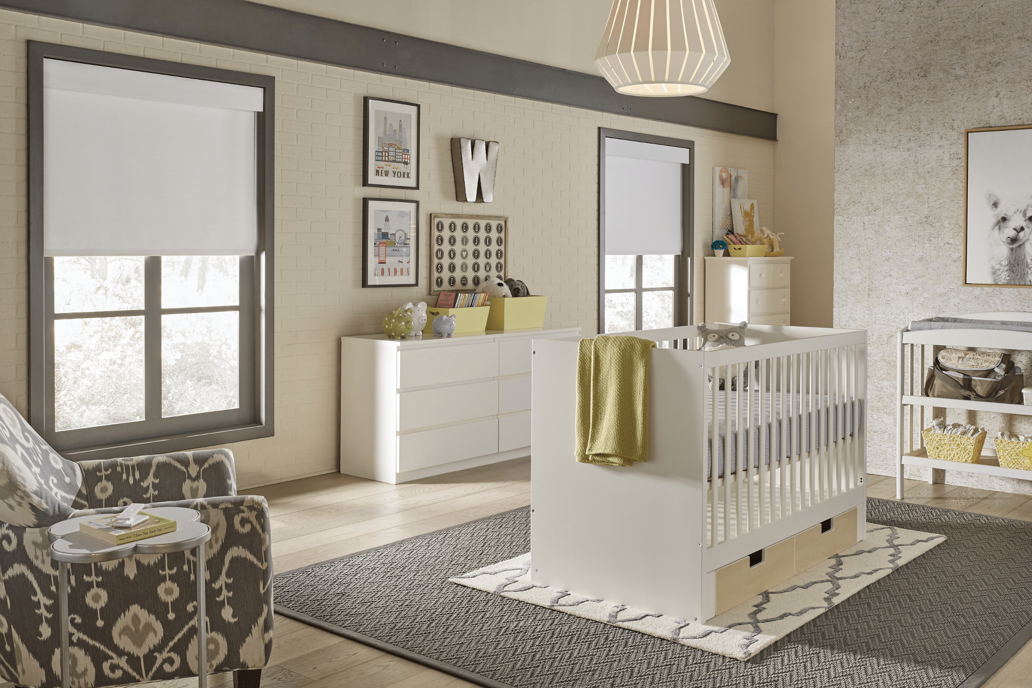 A cozy nursery with a white crib, dresser, armchair, and decorative accents. Soft lighting and neutral tones create a calm atmosphere.