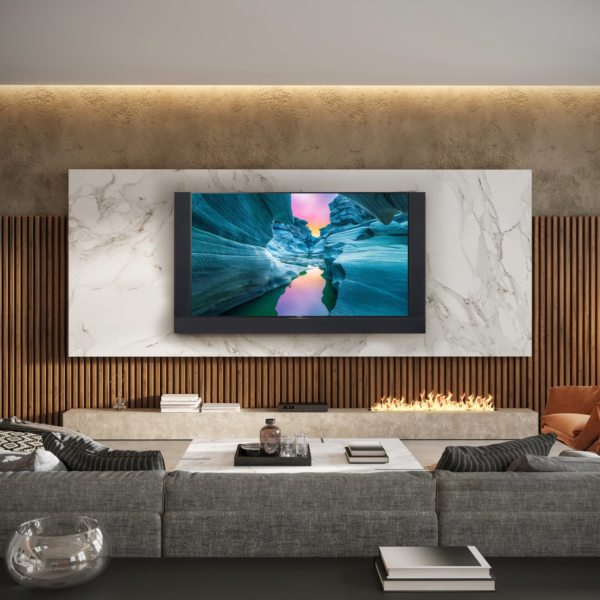 A modern living room with a large wall-mounted TV displaying nature scenery, set above a sleek fireplace. Contemporary decor features wood and marble accents.