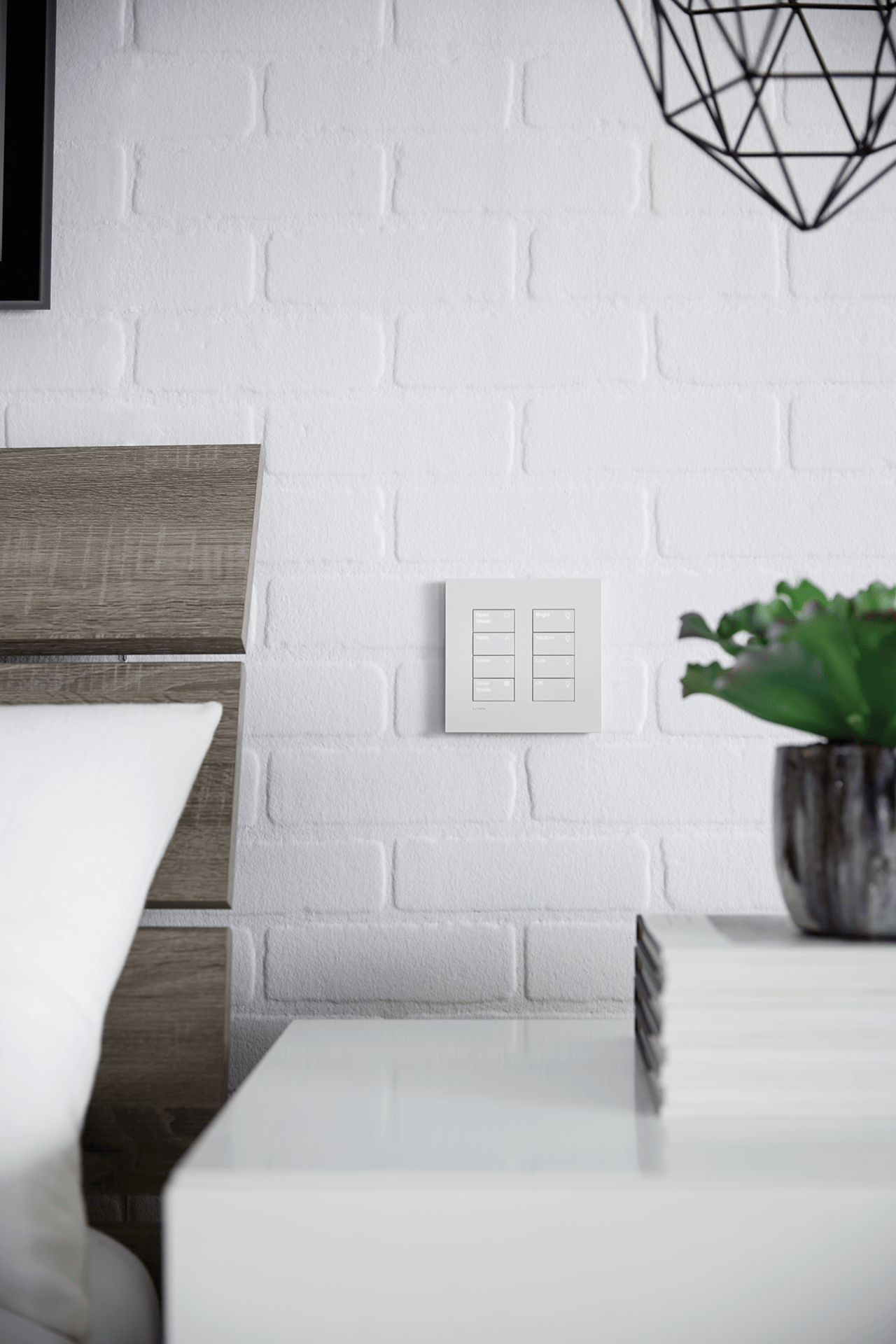 Modern bedroom corner with white brick wall, contemporary geometric light fixture, and sleek furniture. Wooden headboard, books, and a potted plant visible.