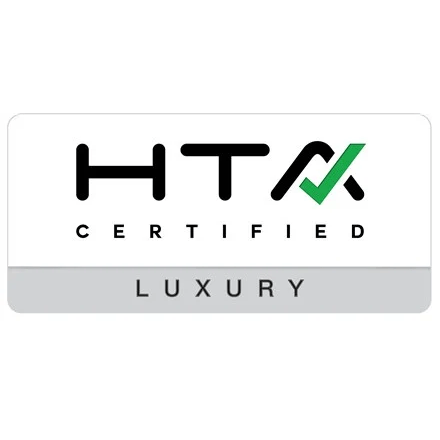 The image shows the HTA Certified logo with "Luxury" written below. A green checkmark completes the letter "A" in the design.