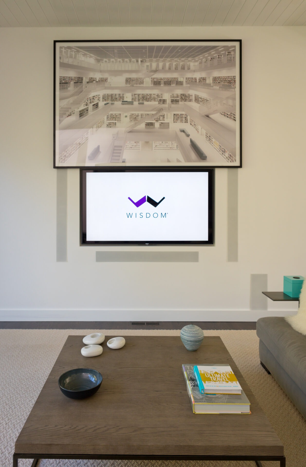 A modern living room features a mounted TV displaying 